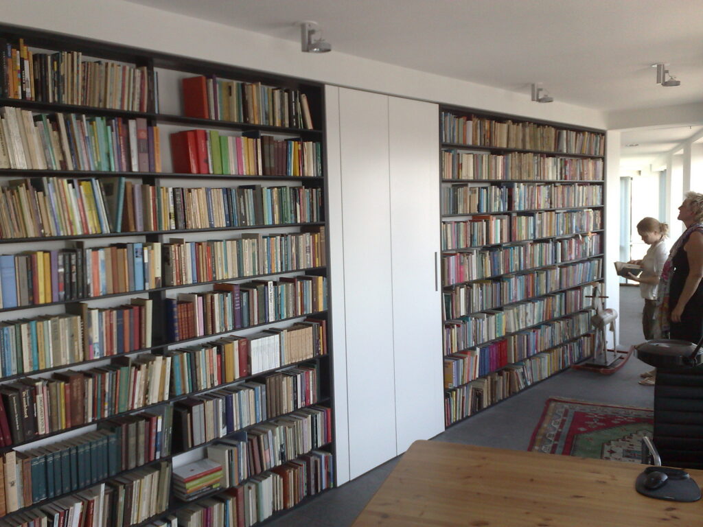 boekenkast, gerookt Eiken ,massief8 meter boekenkast, gerookt Eiken ,massief hout,amsterdam,boekenkast op maat,Boekenwand met kast in het midden die in zijn geheel naar buiten kan scharnieren,scharnierende kast op wielen